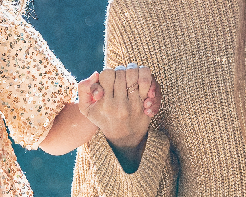 Mother and daughter holding hands during photoshoot