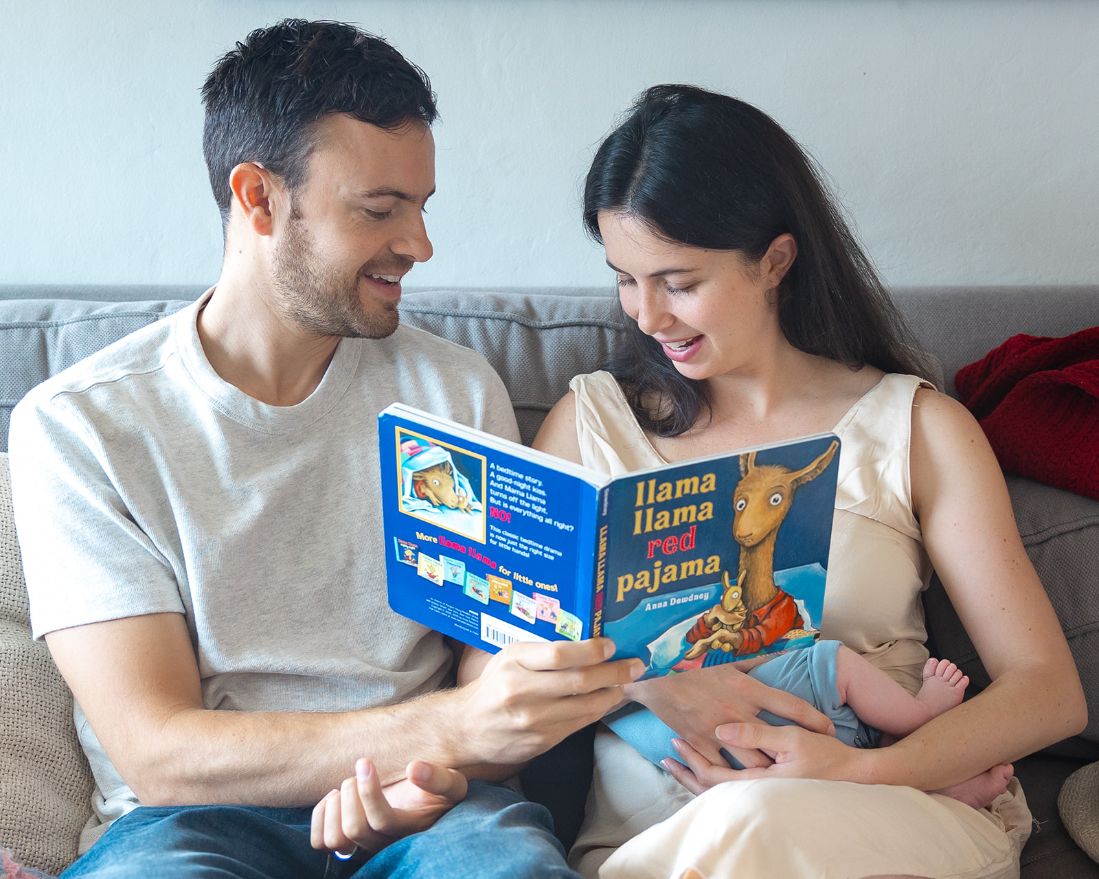 Parents reading baby a book