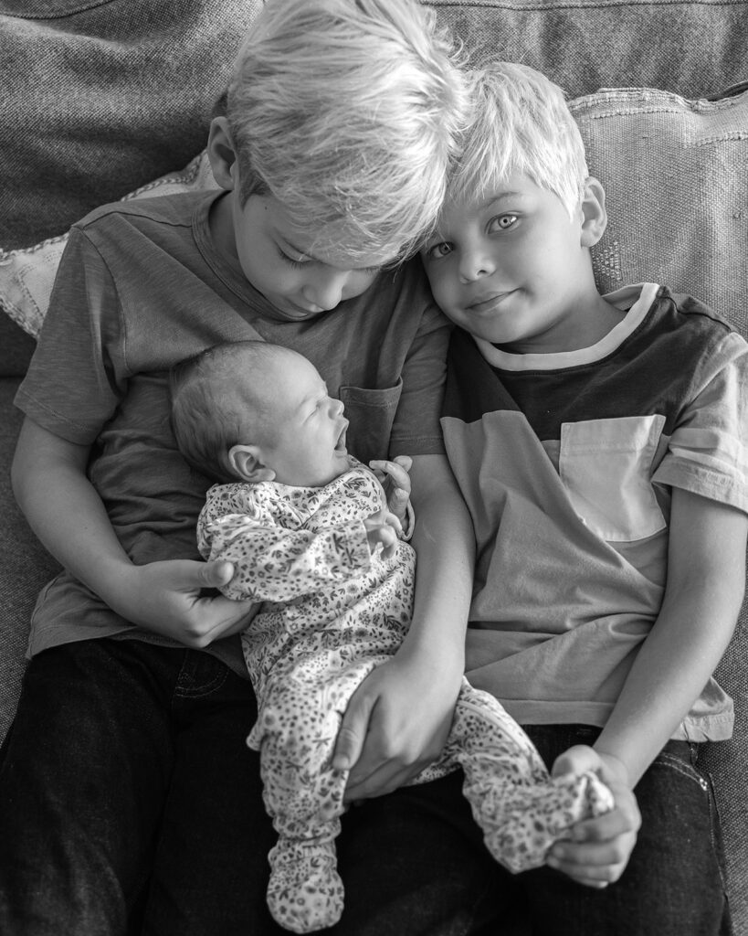 Brother holding baby sister