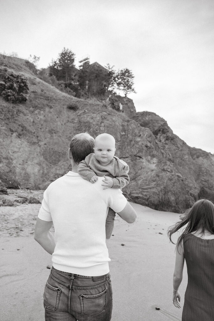 Father holding baby on the beach
