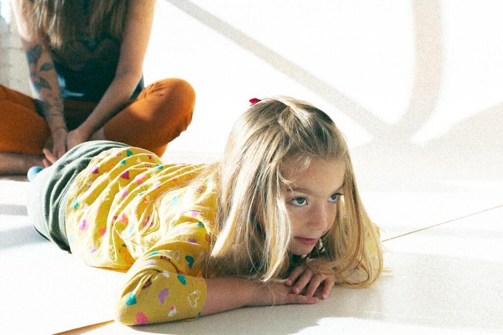 Little girl laying on photo studio floor on 35mm film