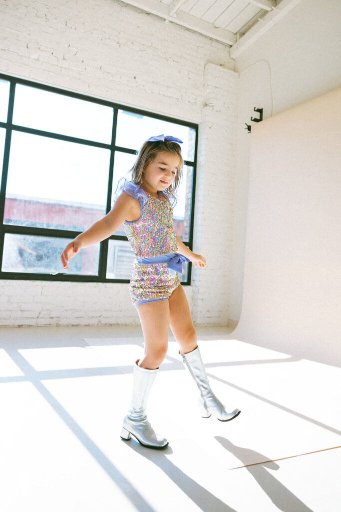 Little girl dancing in a photo studio