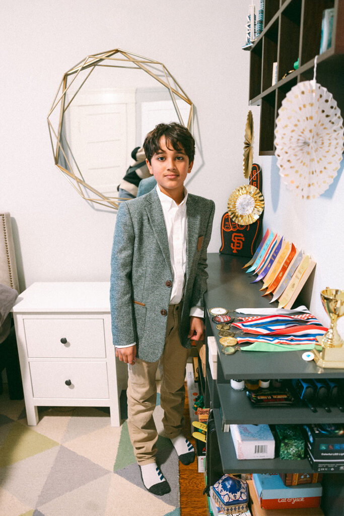 Boy showing off his awards