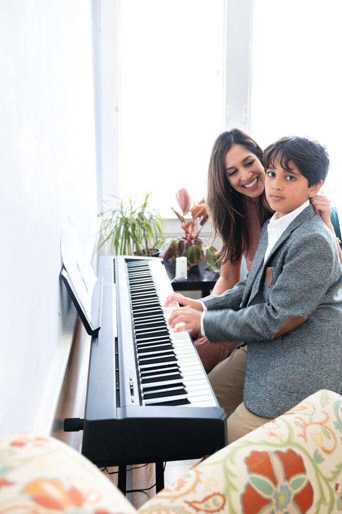 Mother and son playing piano