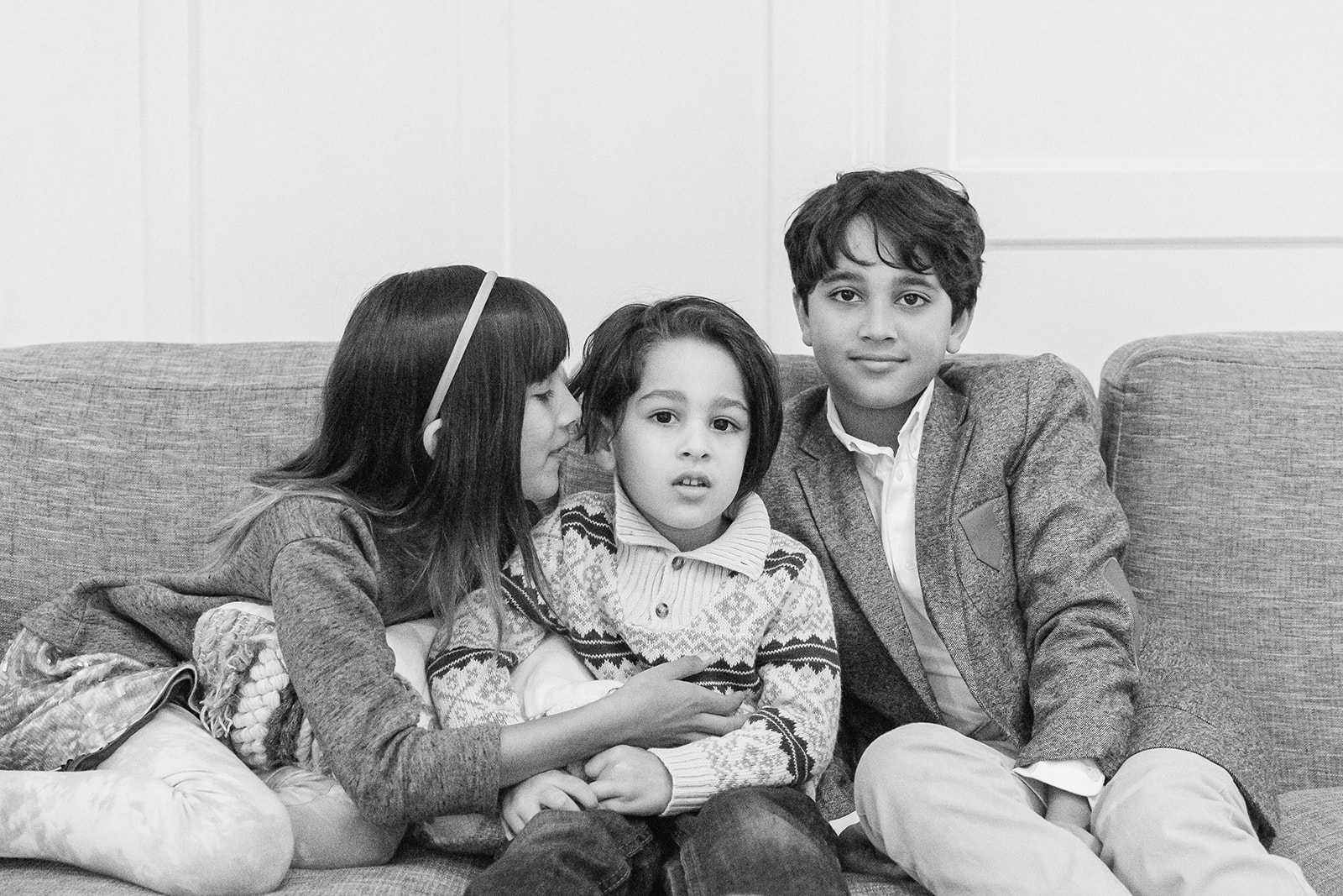 Three siblings sitting on the couch
