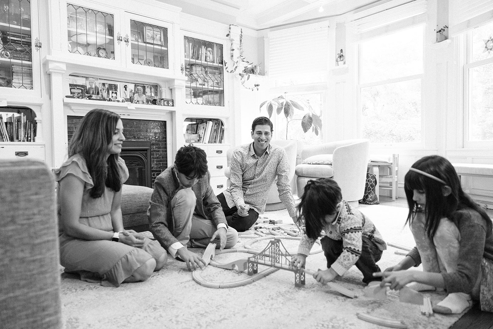 Family playing with toys in their living room during at home family photoshoot in San Francisco