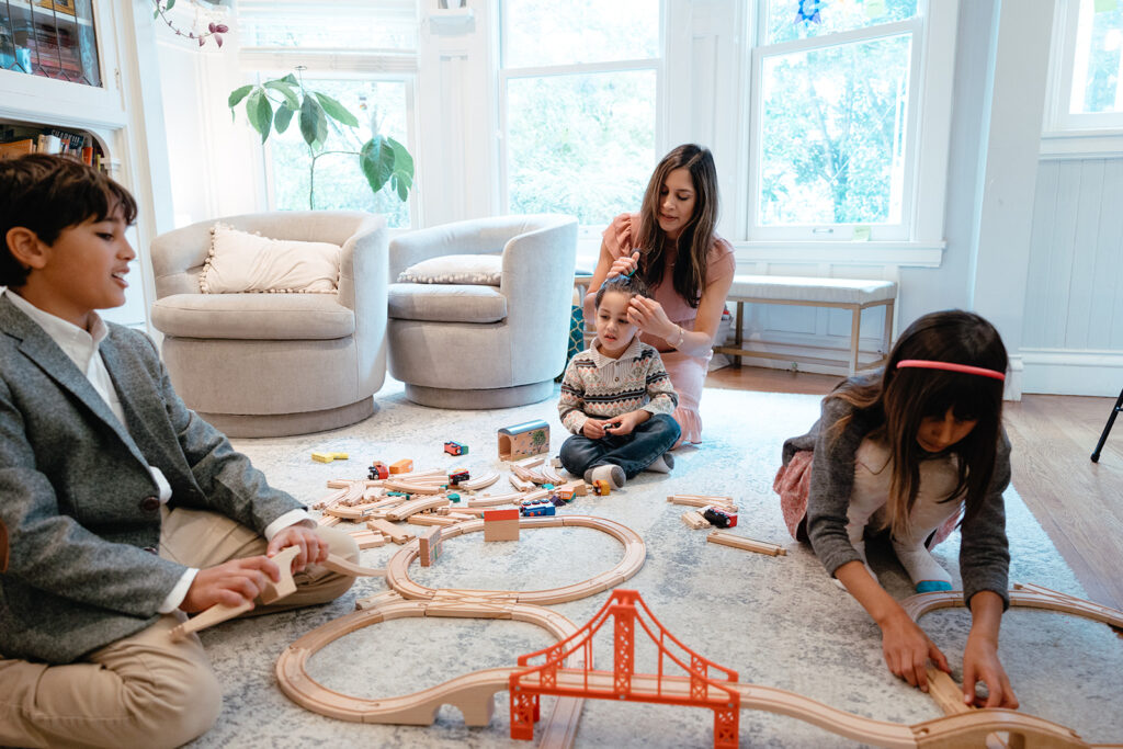 Family playing with toys in their living room during at home family photoshoot in San Francisco