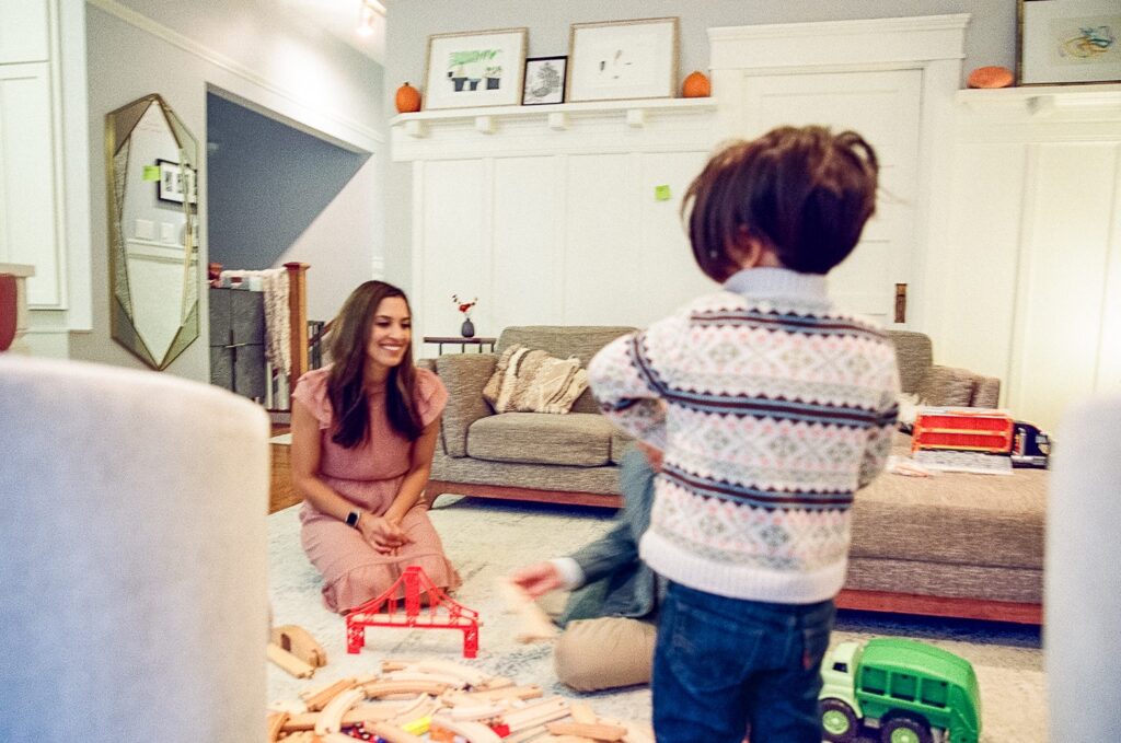 Family playing with toys in their living room during at home family photoshoot in San Francisco