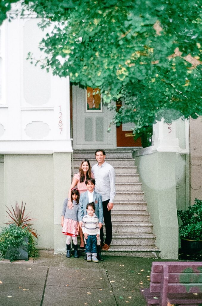 Family standing outside of their house for a family photoshoot in San Francisco on 35mm film