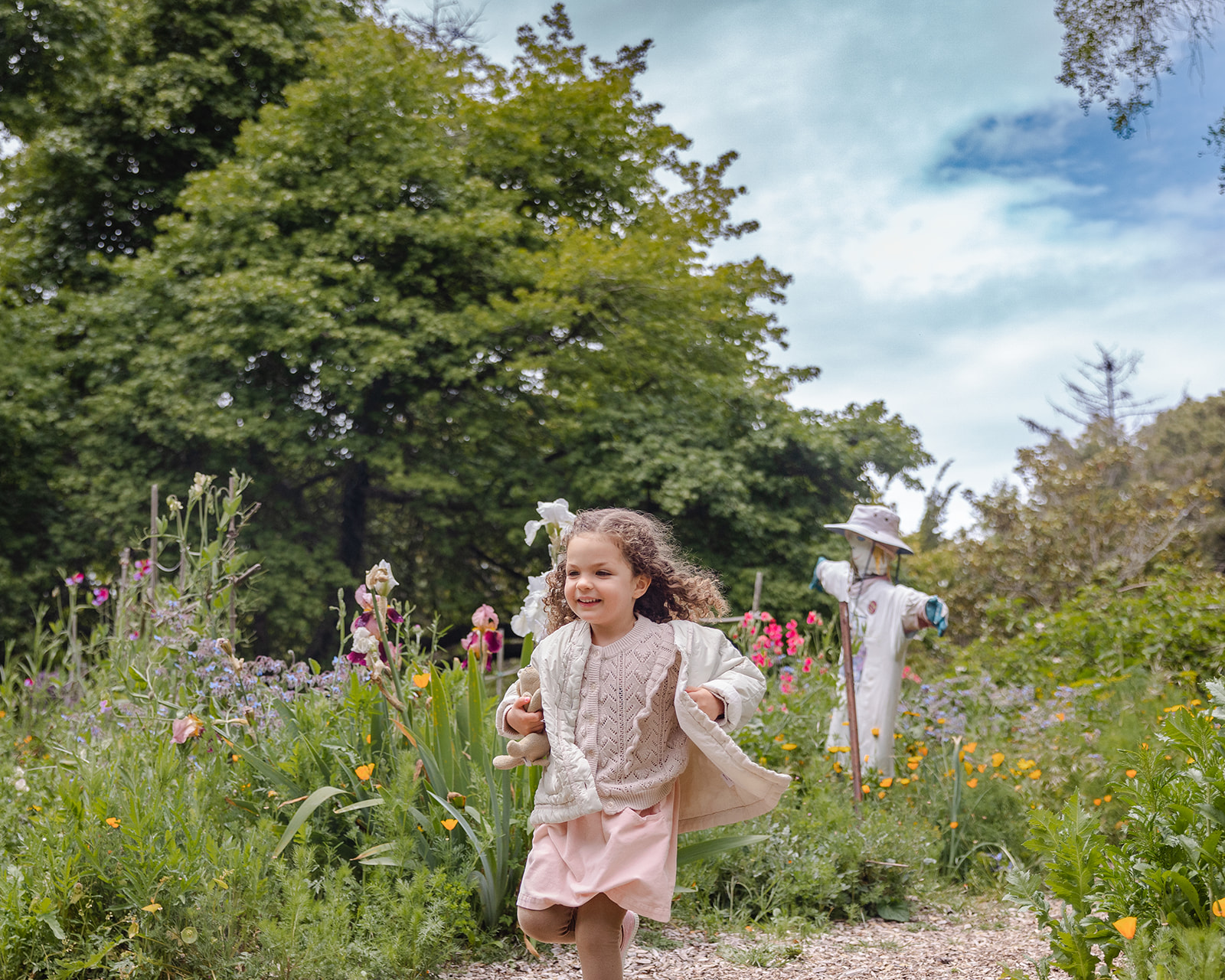 Little girl running at Blake Garden in Berkeley