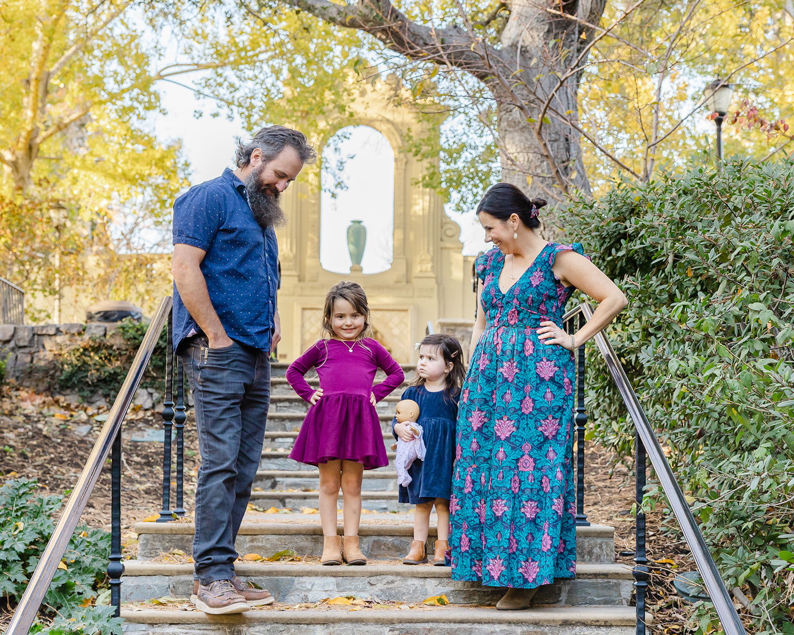 Family of four posing for photos on the steps at Piedmont Community Hall and Park in Piedmont, California 