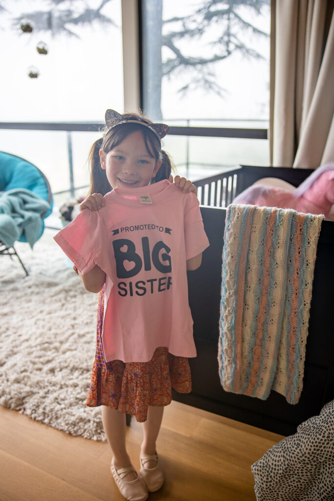 Big sister showing off her shirt