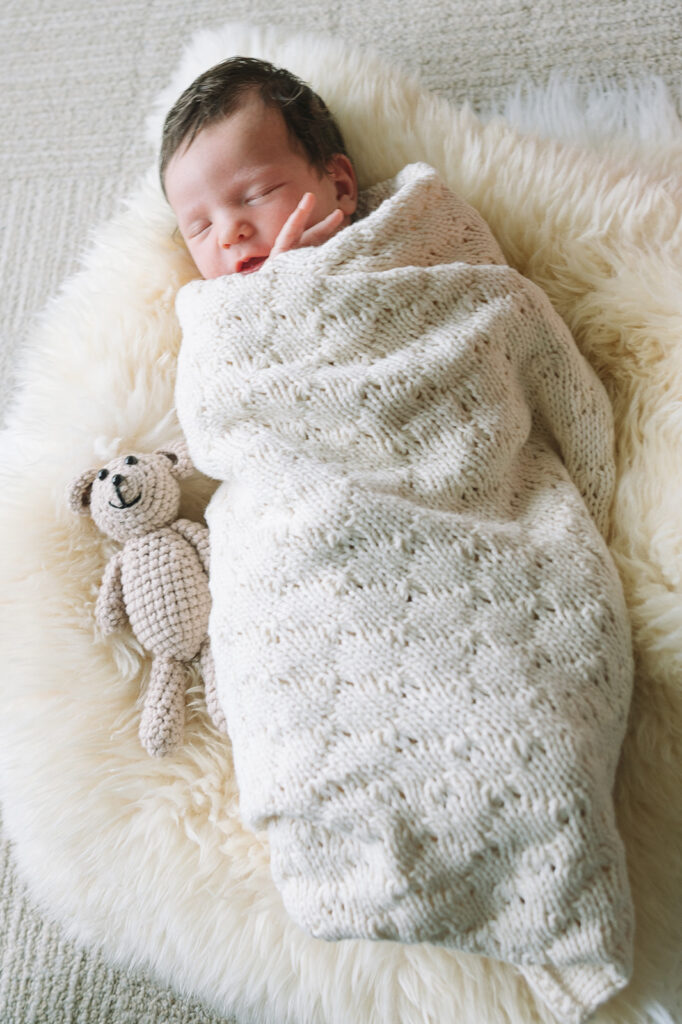 Newborn wrapped in a blanket during at home newborn session in the bay area