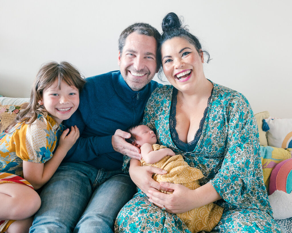 Family of 4 posing for photos during at home newborn session in the bay area
