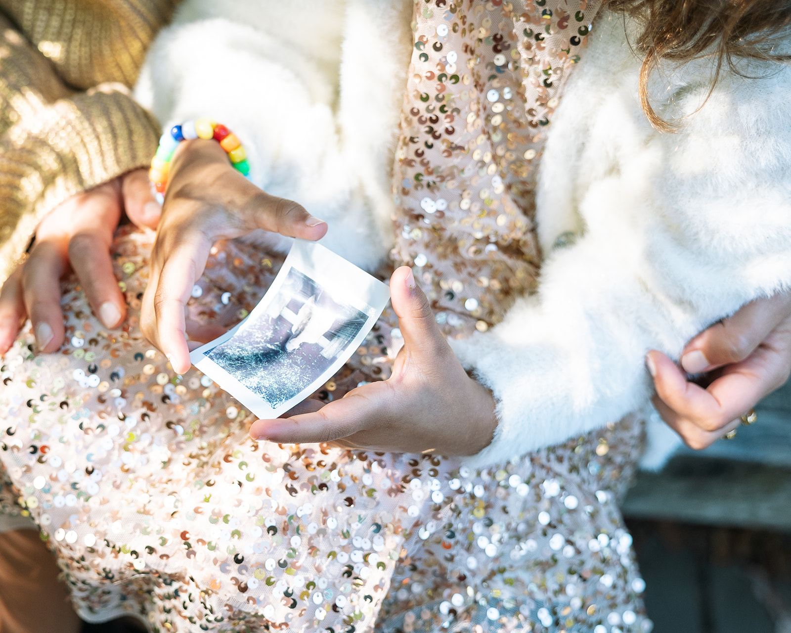 Little girl holding a polaroid photo