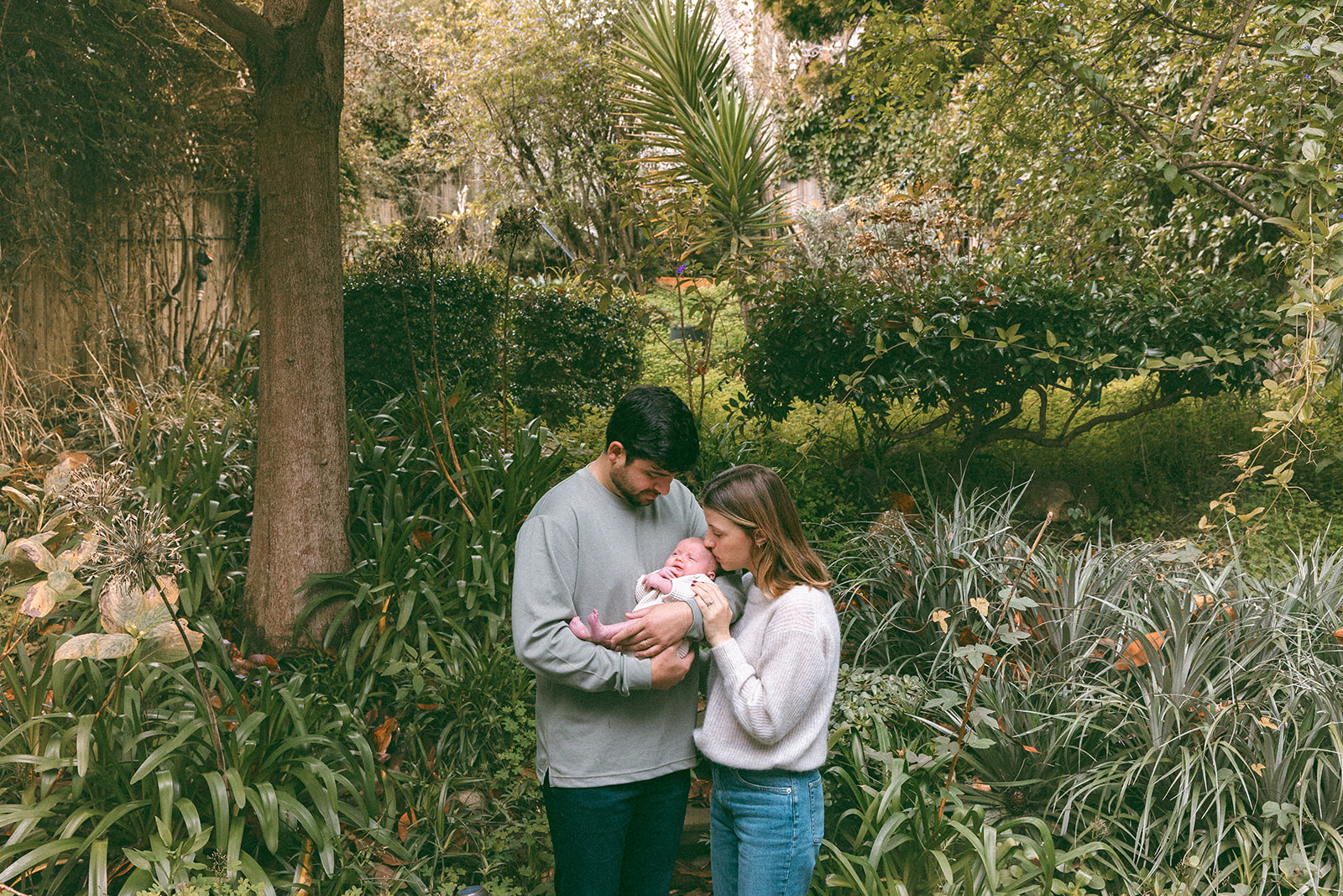Mother and father with their baby outside of their San Francisco home