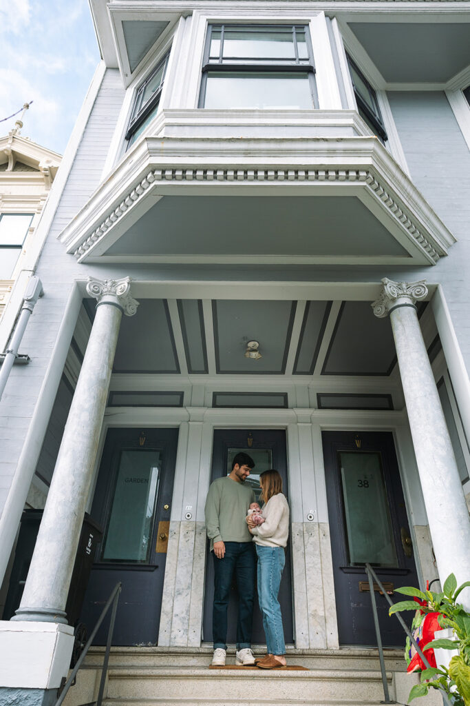 Family standing on their porch at the end of their San Francisco newborn photoshoot