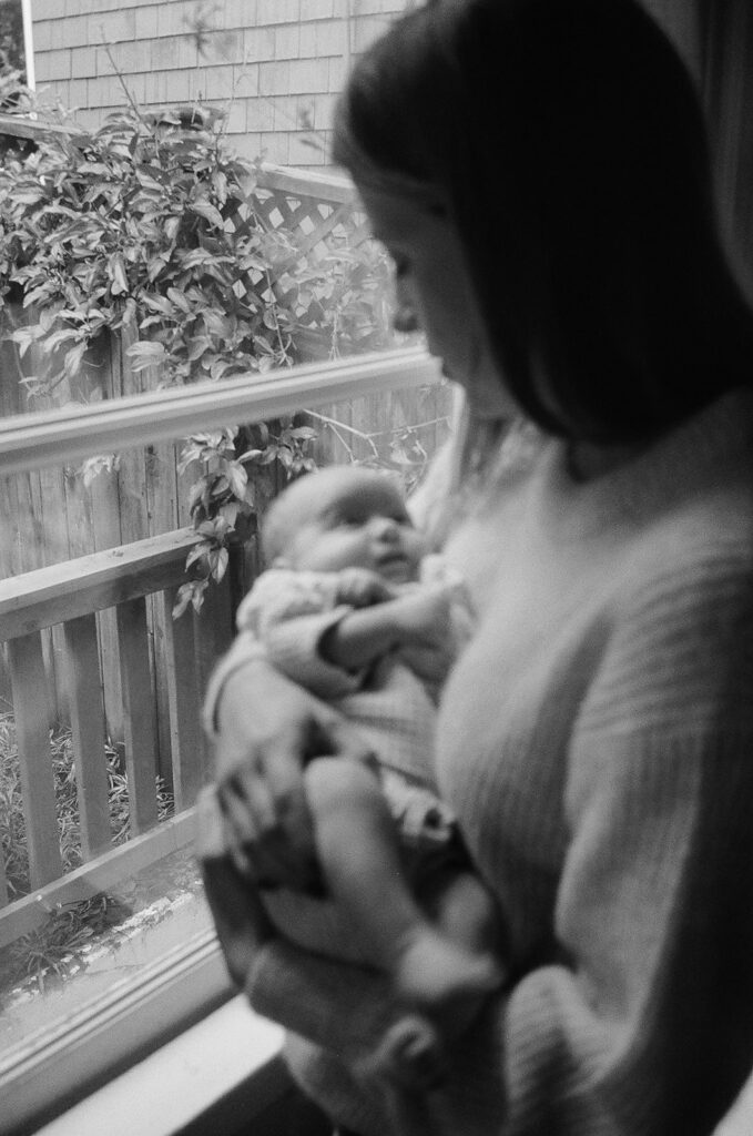 Black and white photo of a mother holding her baby on 35mm film