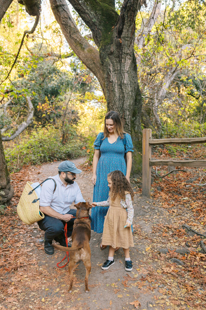 Little girl and her parents exploring the trails at Tilden Regional Park in Berkeley, CA for their maternity & family pictures