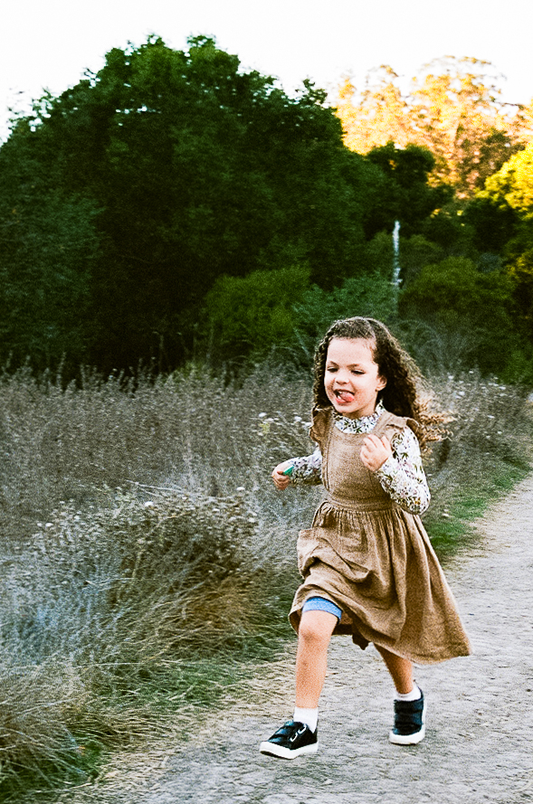 Little girl running the Tilden Regional Park trails in Berkeley, CA on 35mm film