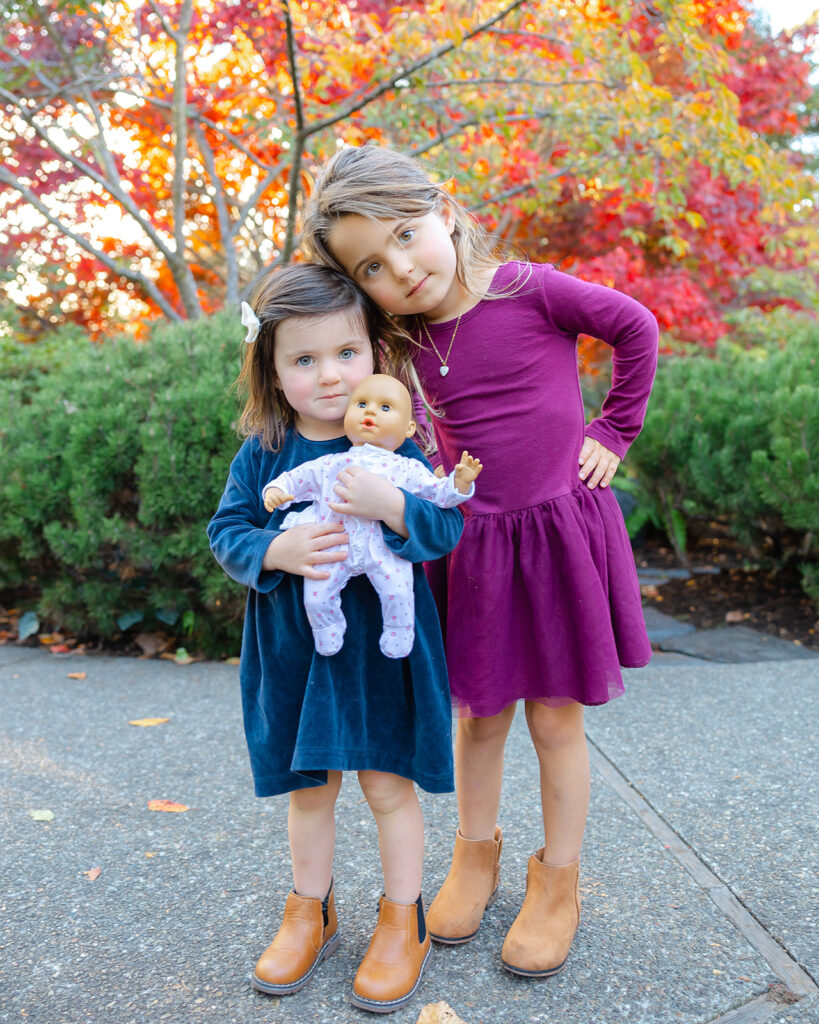 Sisters posing for photos during their fall family photoshoot