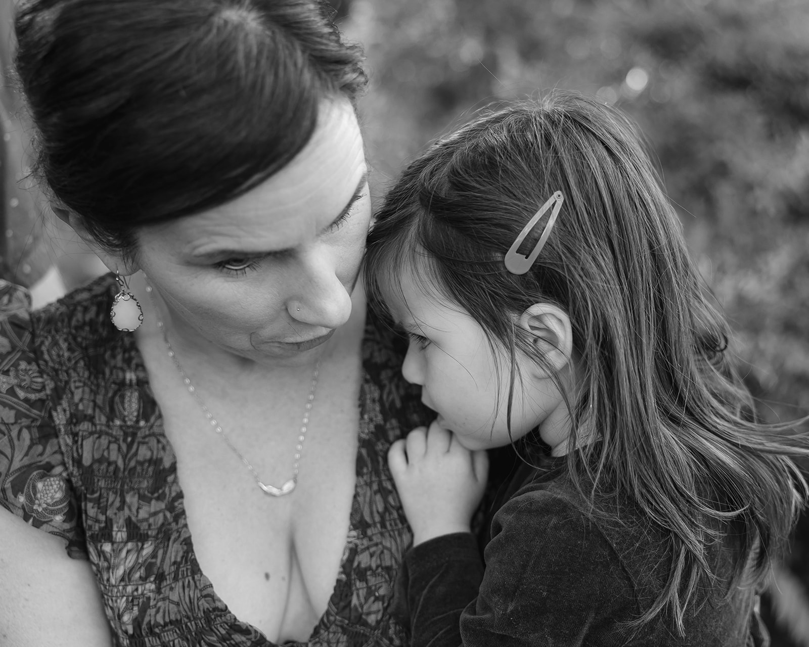 Black and white photo of a mother holding her young daughter