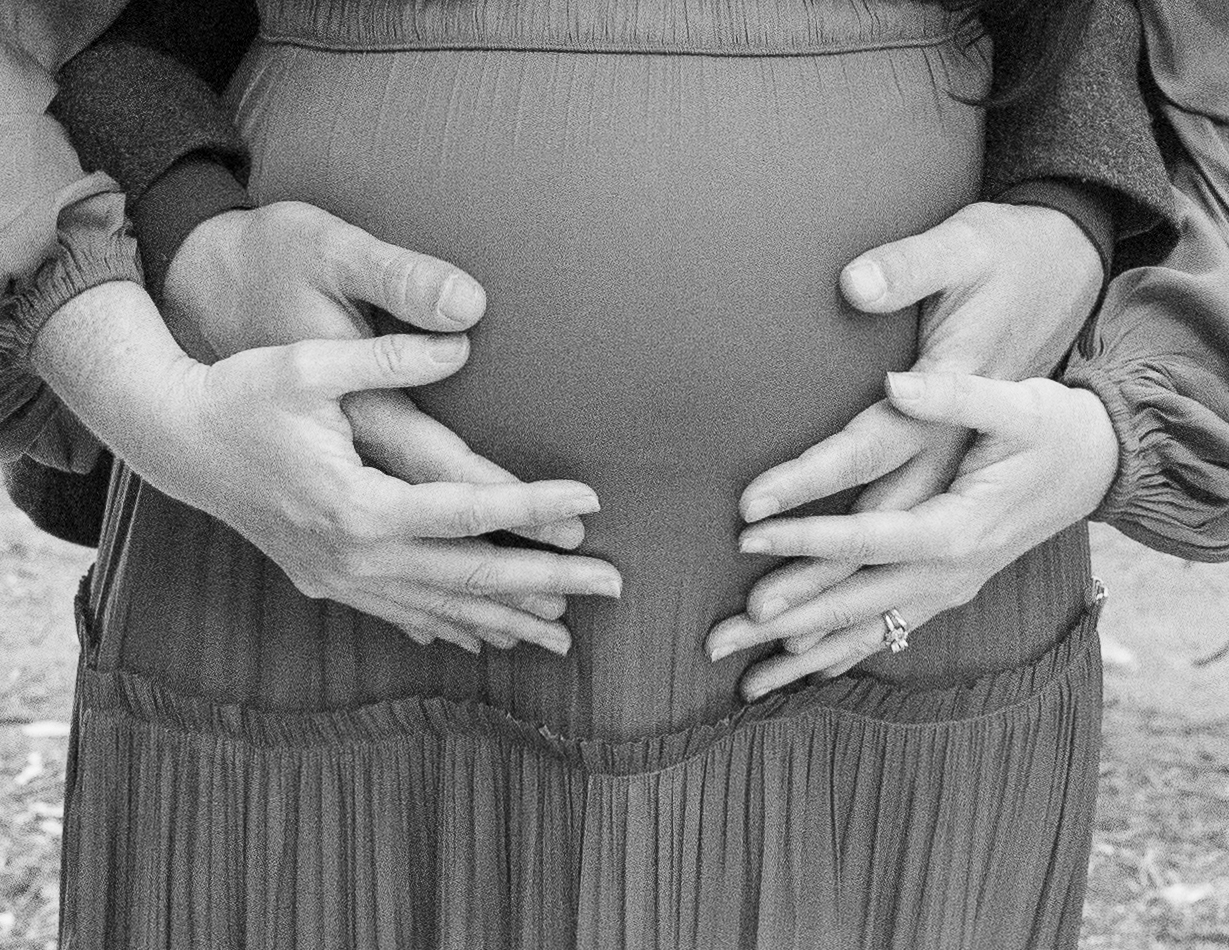 Mother and father holding pregnant mothers belly