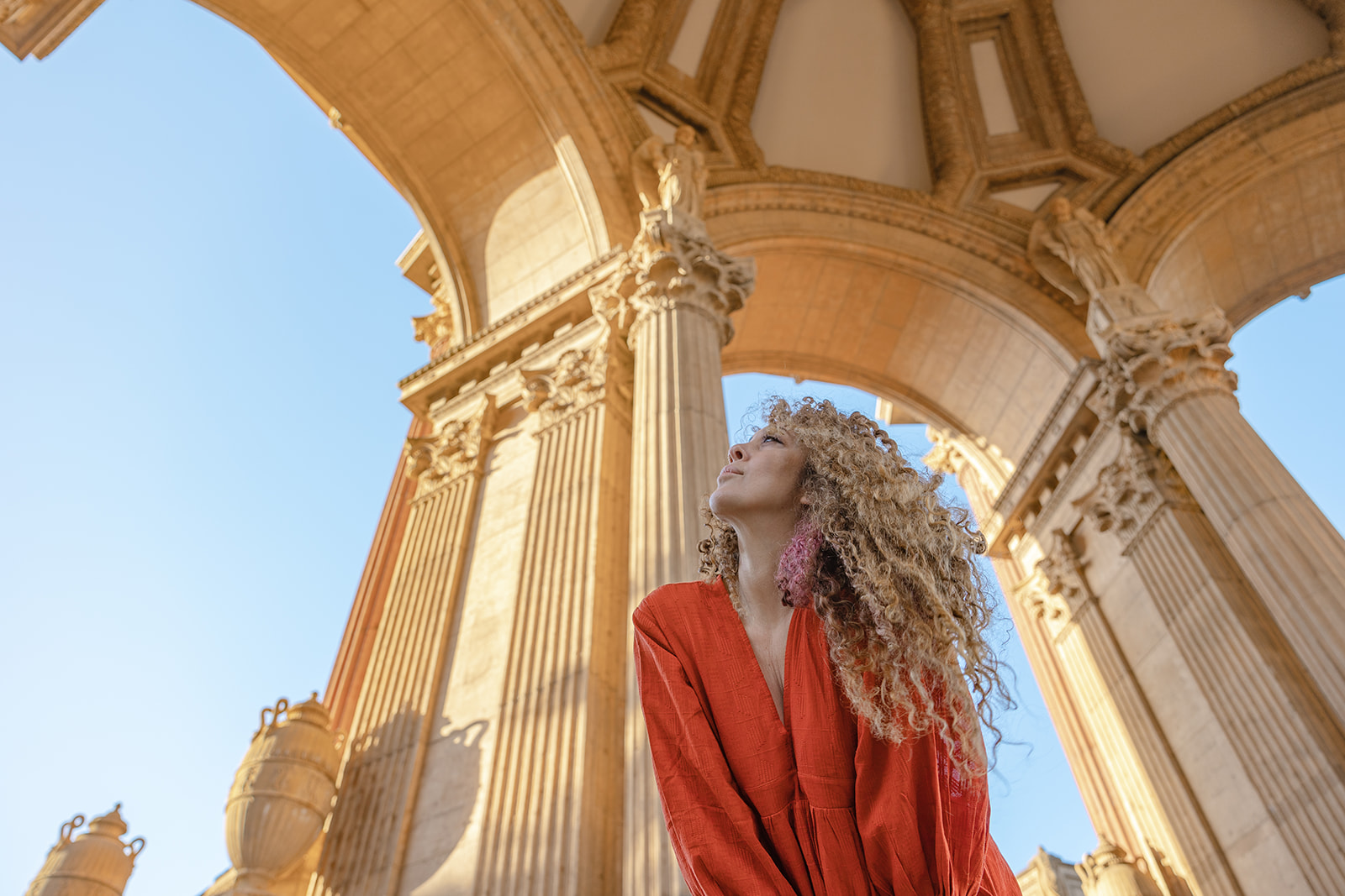 Woman standing inside the Greco-Roman style Rotunda and colonnades at Palace of Fine Arts