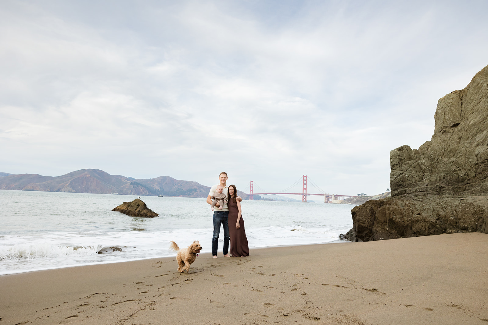 Family of three and their family dog at China Beach for their photoshoot. - Top San Francisco Family Photo Locations