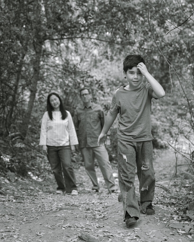 Black and white photo of a family of three walking the trails at Sibley Regional Park for their Oakland CA family photos