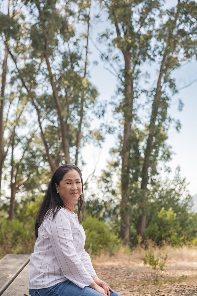 Woman sitting on a bench and smiling at the camera