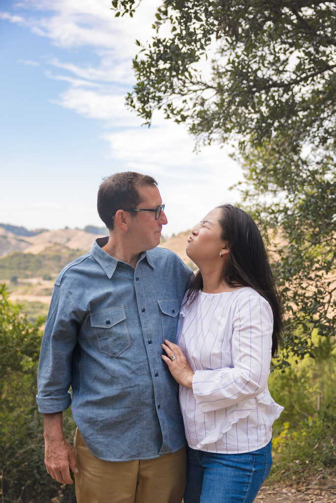 Man and woman smiling at each other for their photos