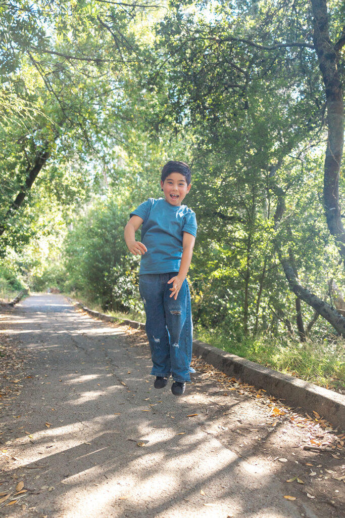 Young boy jumping up in the air