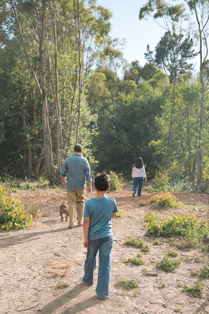 Family of three and their dog walking the trails at Sibley Regional Park for their Oakland CA family photos