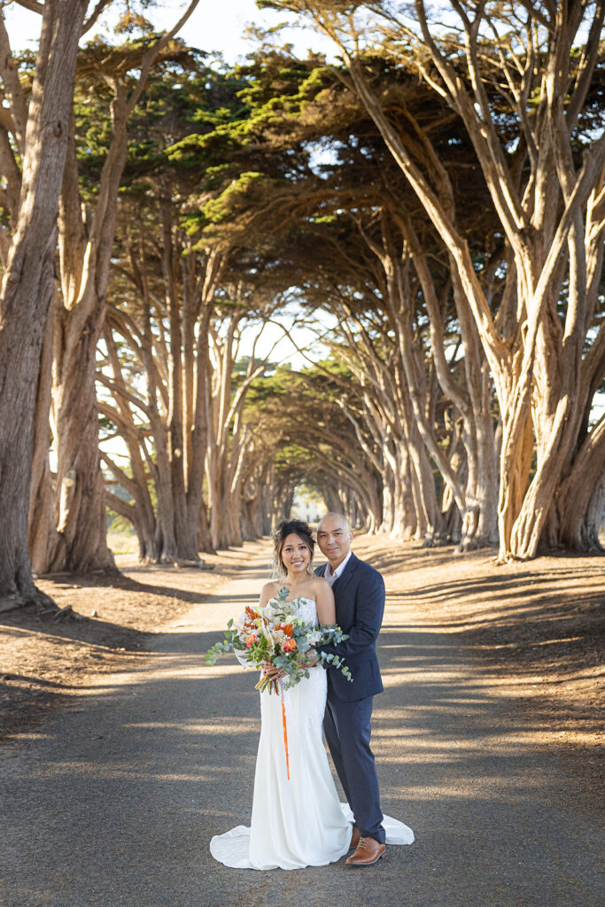 Couple walking along the Cypress Tree Tunnel for their intimate Point Reyes elopement in Northern California