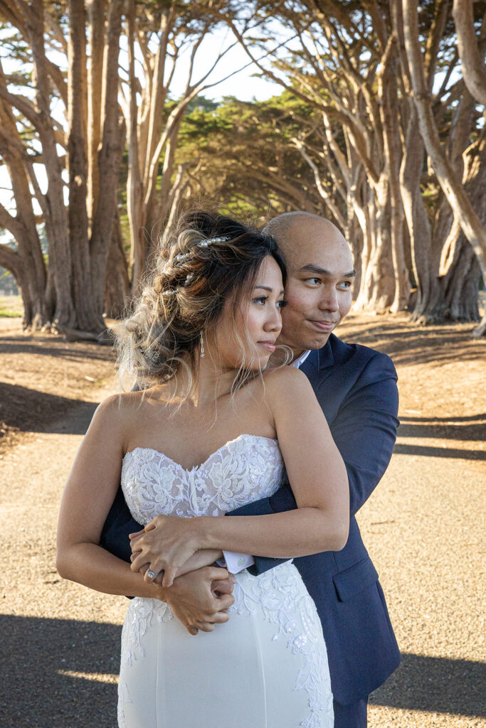 Close up of a bride and groom holding eachother in the Cypress Tree Tunnel. 