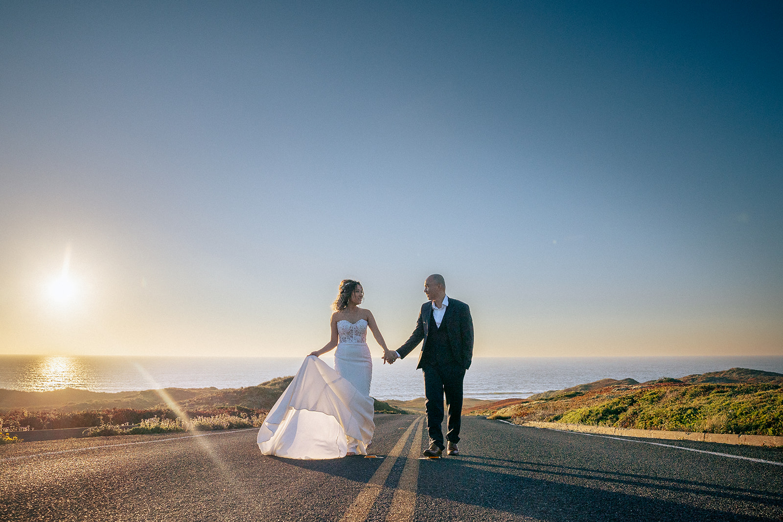 Couple walking along the road during sunset for their intimate Point Reyes elopement in Northern California