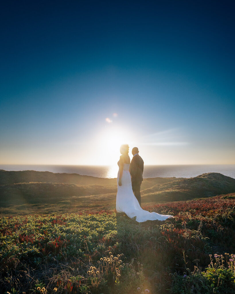 Couple admiring the sunset at Point Reyes during their intimate elopement in Northern California