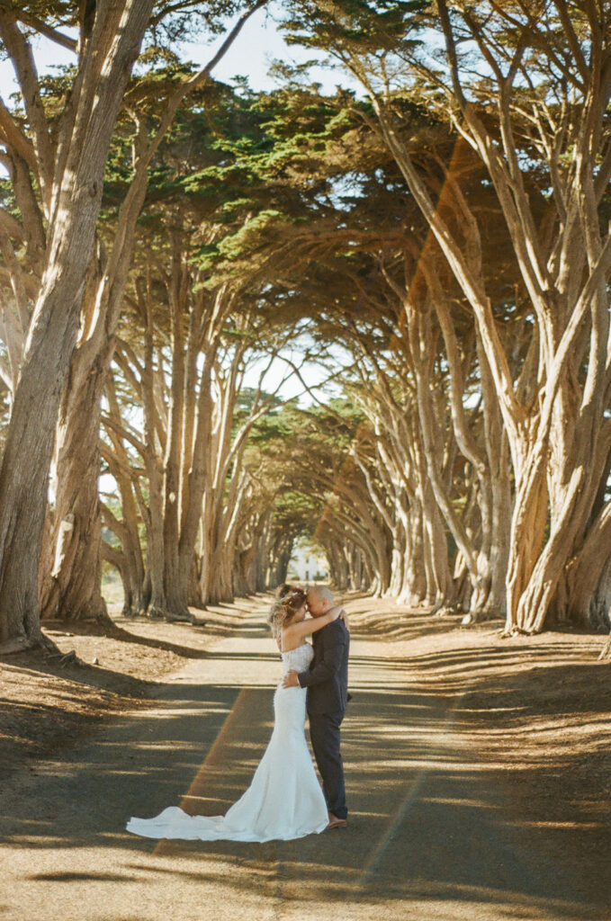 Couple posing in the Cypress Tree Tunnel for their intimate Point Reyes elopement in Northern California