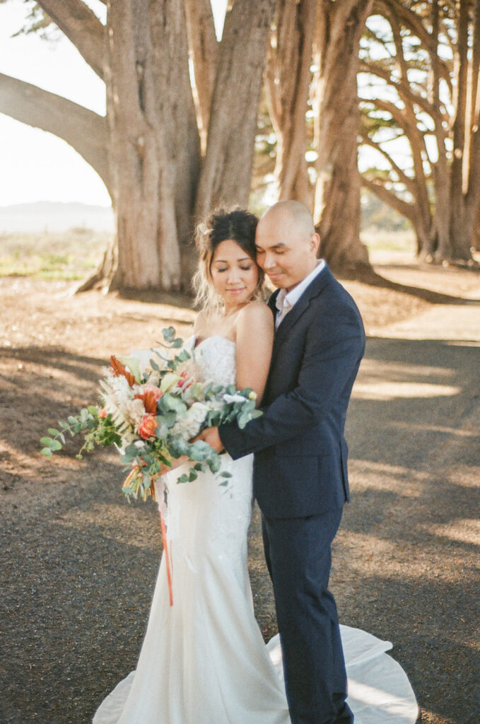 Couple walking along the Cypress Tree Tunnel for their intimate Point Reyes elopement in Northern California captured on 35mm film