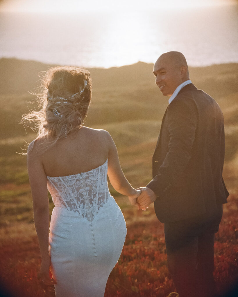 Couple holding each others hands during their intimate Point Reyes elopement in Northern California captured on 35mm film.