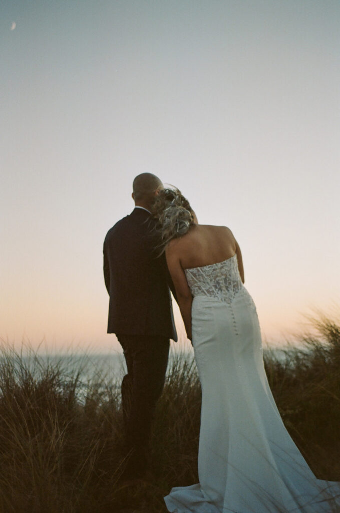 Groom holding up his bride during their intimate Point Reyes elopement in Northern California on 35mm film