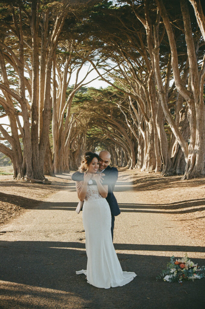 Couple walking along the Cypress Tree Tunnel for their intimate Point Reyes elopement in Northern California