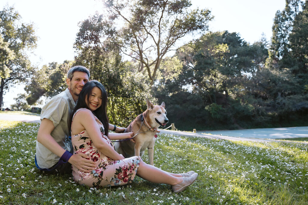 Couple sitting in a park with their dog