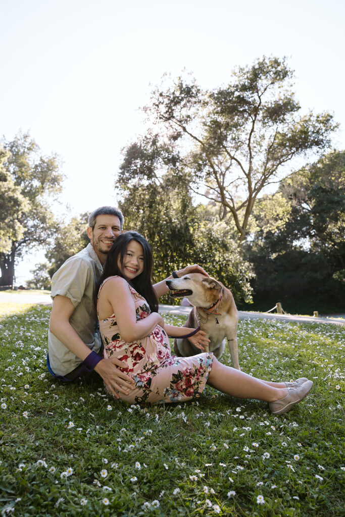 Couple sitting in the park with their dog in Berkeley