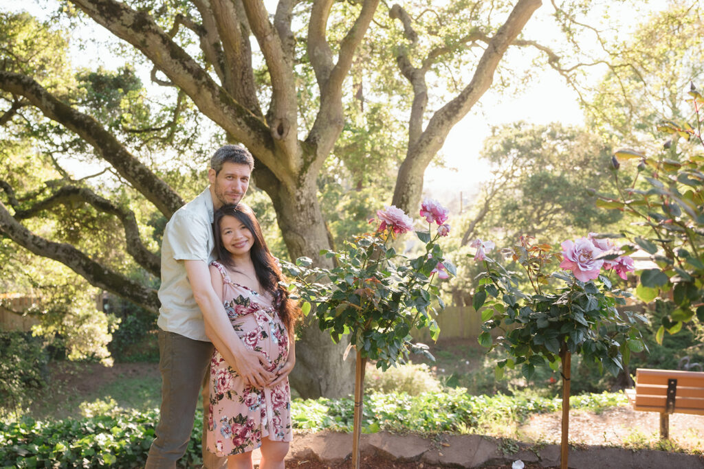 Couple posing for their East Bay maternity photography session at Berkeley Rose Garden