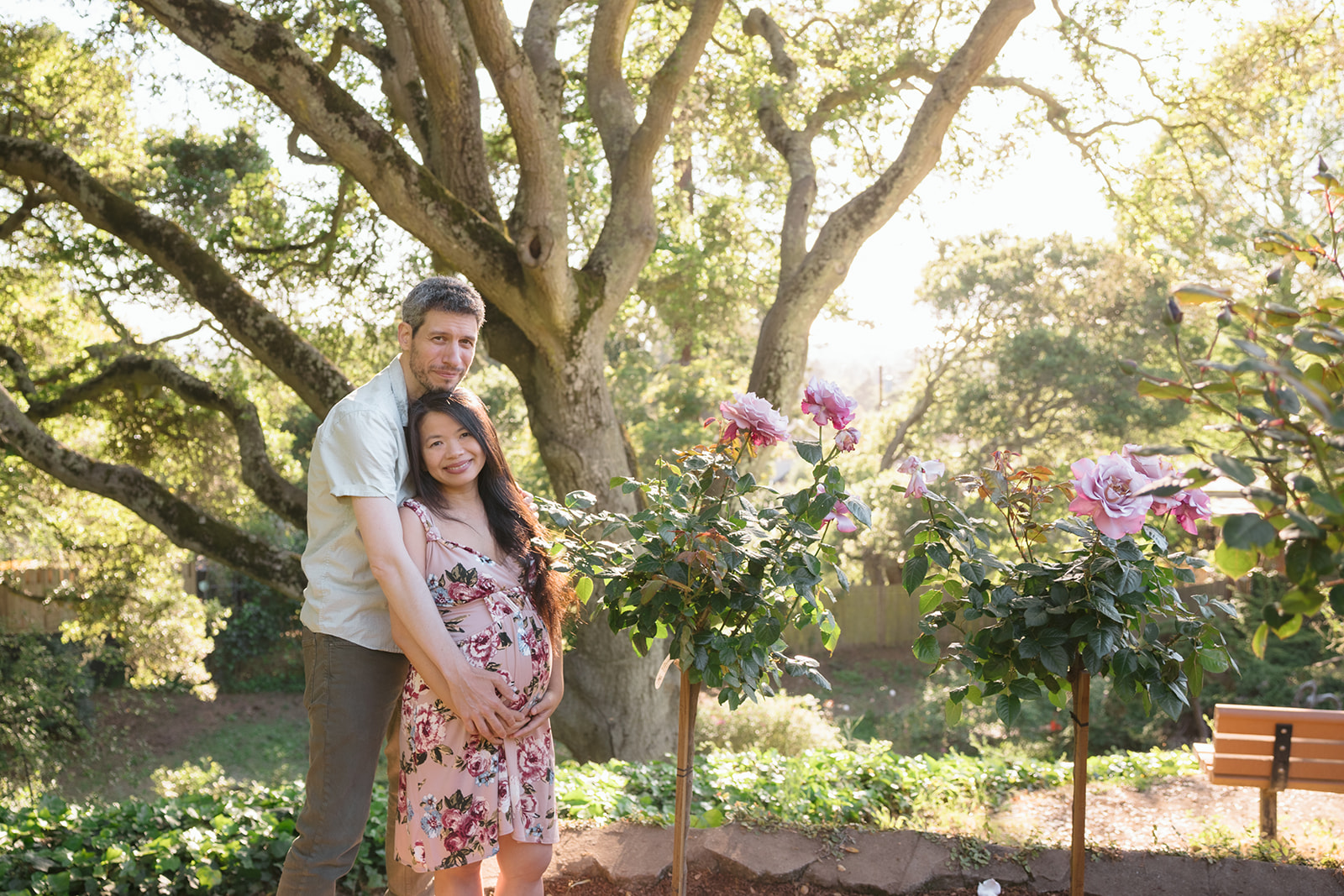 Man and woman posing for their East Bay maternity photography session at Berkeley Rose Garden