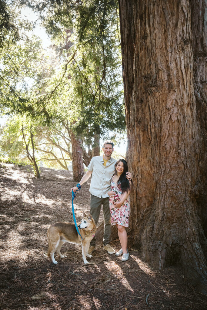 Couple posing for photos with their dog during their East Bay maternity photography session