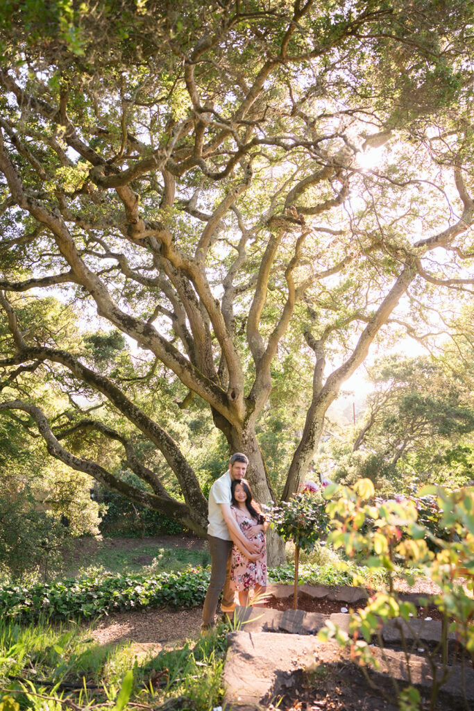 Man and woman posing for their East Bay maternity photography session at Berkeley Rose Garden