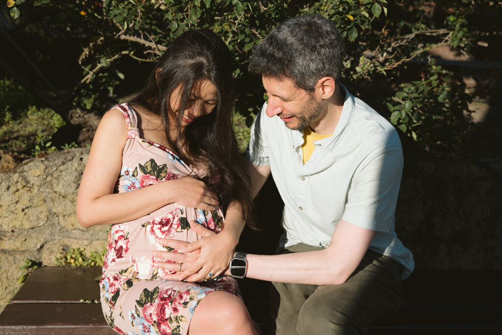 Pregnant woman and man sitting at a Berkeley Park